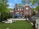 Backyard features artificial turf, a trampoline, a deck with a slide, and an outdoor fireplace at 1116 Dan Johnson Ne Rd, Atlanta, GA 30307