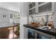 This bar features a wine fridge, glass cabinets and stylish countertop, perfect for entertaining guests at 1116 Dan Johnson Ne Rd, Atlanta, GA 30307
