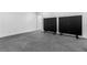 Unfinished basement with gray carpeting and two black privacy screens on wheels at 1116 Dan Johnson Ne Rd, Atlanta, GA 30307