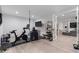 Basement home gym featuring workout equipment and access to another room with built in shelves at 1116 Dan Johnson Ne Rd, Atlanta, GA 30307