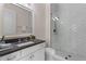 Bathroom featuring a glass enclosed shower, white subway tile in a herringbone pattern, and vanity with dark countertop at 1116 Dan Johnson Ne Rd, Atlanta, GA 30307