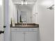 Upstairs bathroom features a vanity with a dark countertop and silver hardware, as well as a large mirror at 1116 Dan Johnson Ne Rd, Atlanta, GA 30307