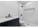 Modern bathroom with subway tile shower, black fixtures, and a navy blue vanity at 1116 Dan Johnson Ne Rd, Atlanta, GA 30307