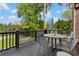 Wooden deck with outdoor seating, overlooking a backyard with a swimming pool and lush greenery at 1116 Dan Johnson Ne Rd, Atlanta, GA 30307