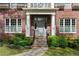 Charming home entrance with elegant brickwork, columns, and lush landscaping, offering a warm and inviting welcome at 1116 Dan Johnson Ne Rd, Atlanta, GA 30307