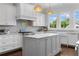 Stylish kitchen with an island, white cabinets, and a stainless steel range at 1116 Dan Johnson Ne Rd, Atlanta, GA 30307