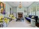Stylish living room featuring pastel colored walls, a cozy fireplace, and unique artwork creating an inviting space at 1116 Dan Johnson Ne Rd, Atlanta, GA 30307