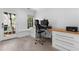 Bright home office with built-in desk, drawers, and natural light from the window and door at 1116 Dan Johnson Ne Rd, Atlanta, GA 30307