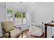Bright sitting area featuring hardwood floors, a comfy chair, and bench seat beneath three large windows at 1116 Dan Johnson Ne Rd, Atlanta, GA 30307