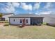 View of a home's backyard with a screen porch and well-maintained lawn and landscaping at 348 Ellington Dr, Canton, GA 30115