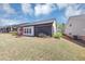 Angle view of a well-maintained yard with a screen porch and surrounding landscape at 348 Ellington Dr, Canton, GA 30115
