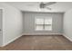 Bedroom with plush carpet, ceiling fan, and a large window providing natural light and comfort at 348 Ellington Dr, Canton, GA 30115