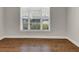 Cozy bedroom showcasing hardwood floors, neutral paint, and a large window, perfect for relaxation at 348 Ellington Dr, Canton, GA 30115
