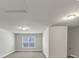 Spacious bonus room has grey carpet and white walls at 348 Ellington Dr, Canton, GA 30115