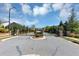 Neighborhood entrance with a black metal gate and brick pillars surrounded by landscaping at 348 Ellington Dr, Canton, GA 30115