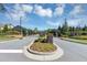 Community entrance with manicured landscaping in the center median at 348 Ellington Dr, Canton, GA 30115