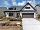 Charming single-Gathering home featuring a two-car garage, attractive landscaping, and classic white painted brick at 348 Ellington Dr, Canton, GA 30115
