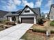 Charming home with a brick and siding exterior, a dark roof, and a well-maintained lawn at 348 Ellington Dr, Canton, GA 30115