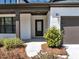 Inviting front entrance with classic white painted brick, covered porch, and well-manicured landscaping at 348 Ellington Dr, Canton, GA 30115