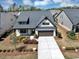 Inviting home with a brick facade, gabled roof, and meticulously landscaped front yard at 348 Ellington Dr, Canton, GA 30115