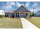 Charming brick home with a welcoming front porch and manicured landscaping at 348 Ellington Dr, Canton, GA 30115