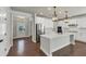 Modern kitchen featuring white cabinets, stainless steel appliances, a large island, and hardwood flooring at 348 Ellington Dr, Canton, GA 30115
