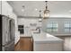 Modern kitchen featuring white cabinets, stainless steel appliances, a large island, and hardwood flooring at 348 Ellington Dr, Canton, GA 30115