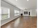 Open-concept living room with hardwood floors, fireplace, large windows, and plenty of natural light at 348 Ellington Dr, Canton, GA 30115