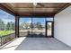 Spacious screened in porch with ceiling fan and view of the yard at 348 Ellington Dr, Canton, GA 30115