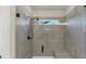 Modern walk-in shower with gray tile, a bench, and a glass enclosure at 348 Ellington Dr, Canton, GA 30115