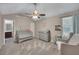 Well lit Bedroom with soft, neutral colors, glider, gray carpeting, and ensuite bath at 373 Hidden Creek Ln, Canton, GA 30114