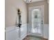 Bright entryway with white wainscoting, a door with blinds, and convenient wall hooks for accessories at 373 Hidden Creek Ln, Canton, GA 30114