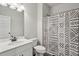 Bright bathroom features a modern vanity with a mirror, toilet, and shower with a stylish patterned curtain at 375 Crider Ct, Woodstock, GA 30188