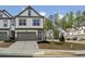 Beautiful townhome with a two-car garage, well-maintained landscaping, and a welcoming front entrance at 375 Crider Ct, Woodstock, GA 30188
