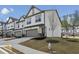 Well-maintained townhomes with landscaped yards, driveways, and street views at 375 Crider Ct, Woodstock, GA 30188