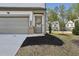 Charming front exterior shows landscaped yard and attached garage, enhancing curb appeal at 375 Crider Ct, Woodstock, GA 30188