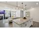 Open concept kitchen with granite countertops, stainless steel appliances, and modern lighting at 375 Crider Ct, Woodstock, GA 30188