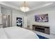 Main bedroom featuring a modern tv, electric fireplace, modern chandelier, and gray interior at 375 Crider Ct, Woodstock, GA 30188