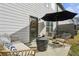 Cozy patio features stylish wicker furniture, a modern fire pit, and a shade umbrella for outdoor relaxation at 375 Crider Ct, Woodstock, GA 30188