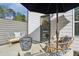 Charming patio area with comfortable seating, stylish decor, and an umbrella for shade at 375 Crider Ct, Woodstock, GA 30188