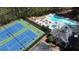 Aerial shot of community amenities including a swimming pool, tennis courts, and outdoor seating at 7470 Princeton Trce, Sandy Springs, GA 30328