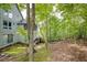 Beautiful backyard with wooded scenery, trees and foliage, and stairs leading to the house at 7470 Princeton Trce, Sandy Springs, GA 30328