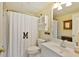Bright bathroom featuring white fixtures, a decorative shower curtain, and built-in storage at 7470 Princeton Trce, Sandy Springs, GA 30328
