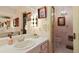 Vintage bathroom with dual sinks, a chandelier, and pink accents at 7470 Princeton Trce, Sandy Springs, GA 30328