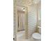 Floral wallpaper adorns this bathroom with a toilet and shower with curtain at 7470 Princeton Trce, Sandy Springs, GA 30328
