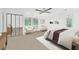 Bright bedroom with a ceiling fan, two chairs, and view of nature through large windows at 7470 Princeton Trce, Sandy Springs, GA 30328