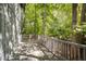 Outdoor deck overlooking a lush, green, wooded backyard with mature trees and plenty of natural light at 7470 Princeton Trce, Sandy Springs, GA 30328
