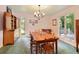 Cozy dining room featuring a rustic wooden table, traditional furniture, and views of the serene, tree-filled landscape at 7470 Princeton Trce, Sandy Springs, GA 30328