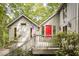 Charming home featuring a bright red door, gray siding, and an inviting porch, perfect for enjoying the surrounding greenery at 7470 Princeton Trce, Sandy Springs, GA 30328