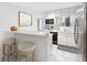 This kitchen has white cabinets, stainless steel appliances, and a breakfast bar with seating at 7470 Princeton Trce, Sandy Springs, GA 30328